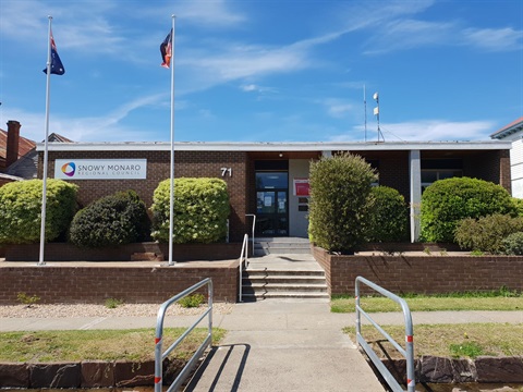 Council's Bombala office on a sunny day, a red brick veneer single-storey building with Australian and Aboriginal flags flying