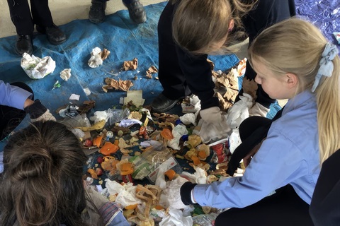 Children sort waste with instructor at EnviroMentors event