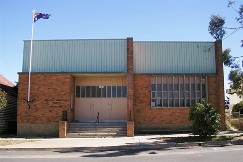 An image of the red brick front-exterior of Nimmitabel Pioneers Memorial Hall