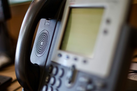 Close-up photo of an office landline IP phone with shallow depth-of-field