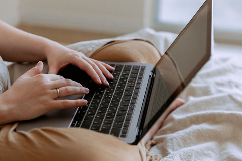 Woman reading on laptop computer