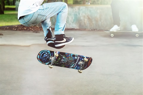 Young people skateboarding outdoors in a park